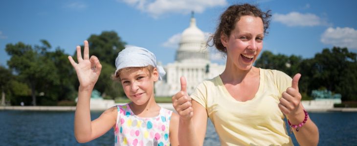 a mother and daughter pose together in front of The Capitol Building in Washington, DC