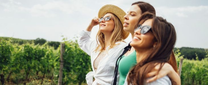three friends touring a vineyard